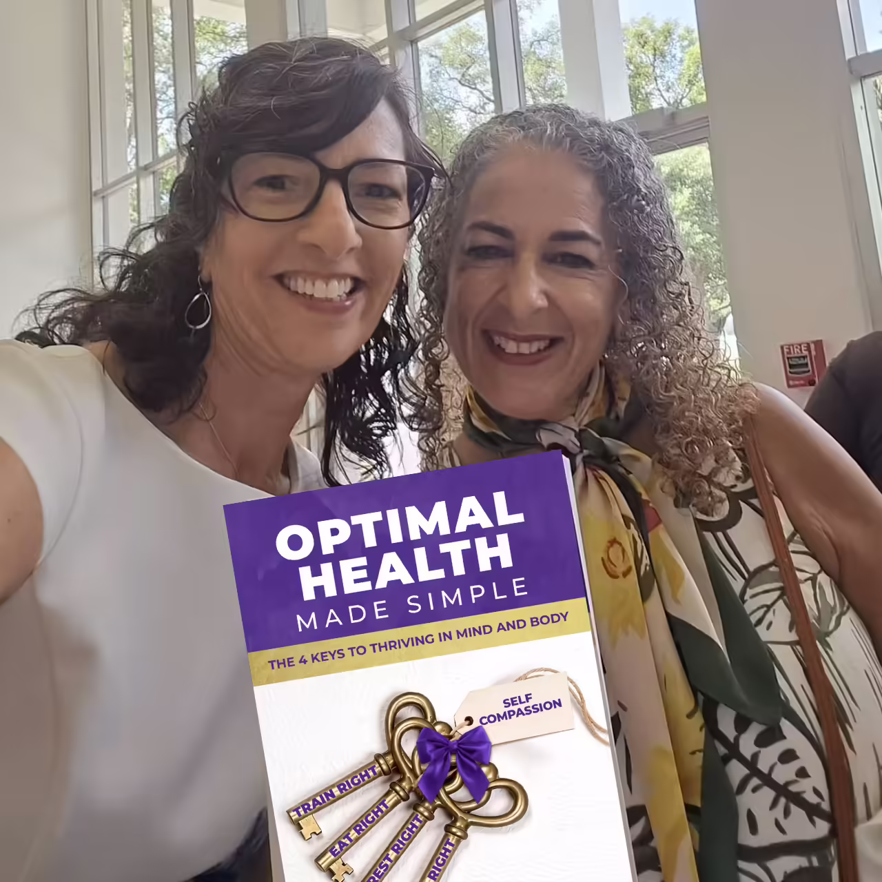Patty Durell at an event with a friend and sponsor display
